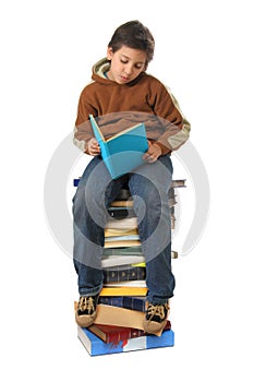 Student sitting on a pile of books