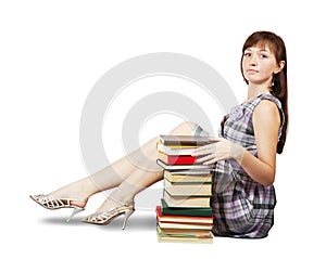 Student sitting with pile of books