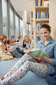 Student sitting in school library with friends