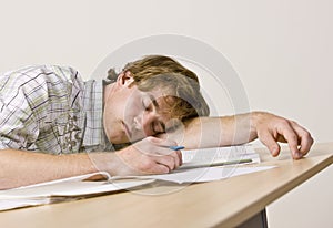 Student sleeping at desk in classroom