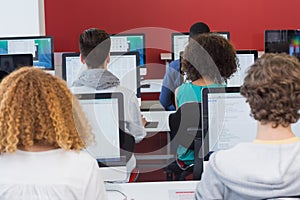 Student smiling at camera in computer class