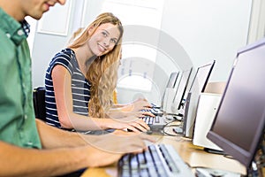 Student smiling at camera in computer class