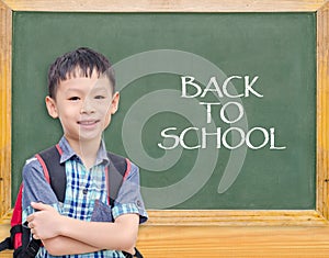 Student smiling in front of chalkboard