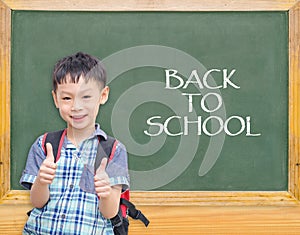 Student smiling in front of chalkboard