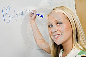 Student Solving Algebra Equation On Whiteboard