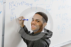 Student Solving Algebra Equation On Whiteboard photo