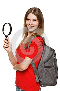 Student standing with magnifying glass