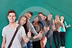 Student Standing In Row Against Green Background