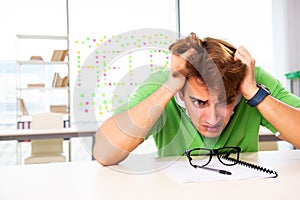 The student struggling at the exam in classroom