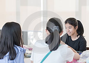 Student study group working together on high school class assignment project discussion in library room for college or university