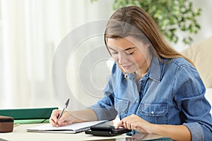 Student studying calculating with a calculator