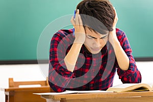 student studying for exam in classroom