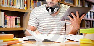 Student studying in library with tablet