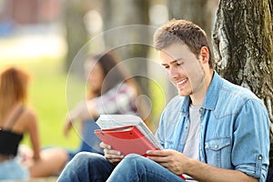 Student studying memorizing notes outdoors photo