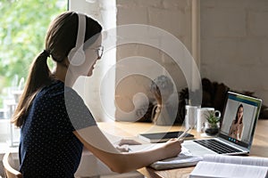 Student studying with schoolmate remotely use laptop and video call photo