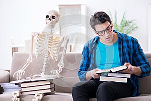 The student studying with skeleton preparing for exams