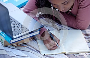 Student, studying and woman writing notes from research assignment for college or university academic education. Park