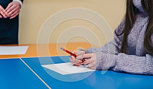 Student takes the test or exam in class. Examiner testing in examination room. Concept for scholarship to study abroad