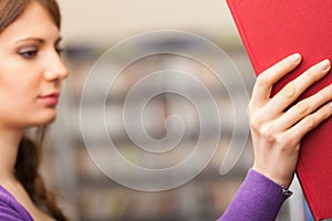 Student taking a book in a library