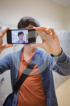 Student taking his selfie on smartphone