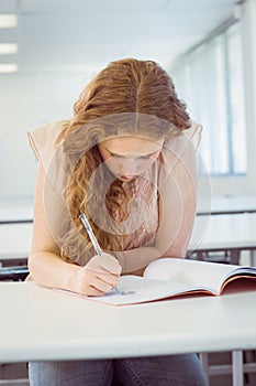 Student taking notes in class