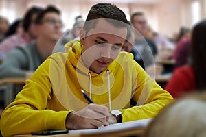 student taking notes while studying in high school