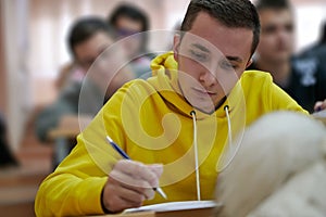 student taking notes while studying in high school