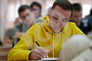 student taking notes while studying in high school