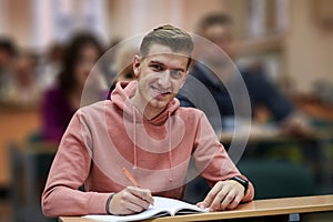 student taking notes while studying in high school