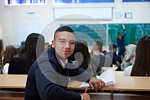 student taking notes while studying in high school