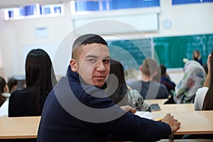 student taking notes while studying in high school