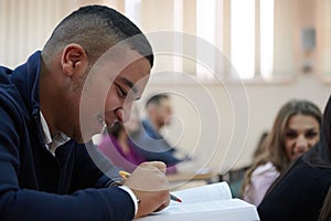 student taking notes while studying in high school