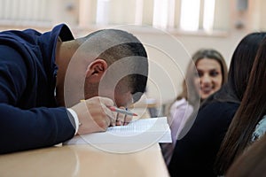 student taking notes while studying in high school