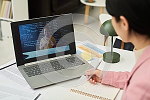 Student Watching Online Language Class on Laptop Screen
