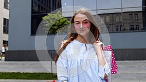 Student teen girl with shopping bags. Good Black Friday holiday sale discounts, low price purchases