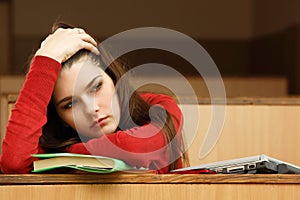 Student teen girl tired in empty classroom university