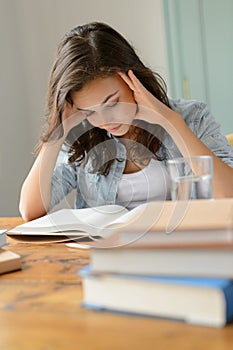 Student teenage girl concentrate reading book home