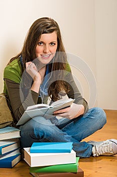 Student teenager woman hold book listen music