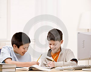 Student with text books helping friend do homework