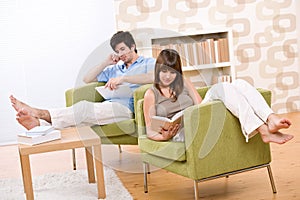 Student - two teenager reading book in lounge