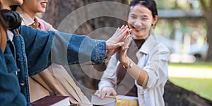 Student university friendship concept with classmate sitting together at campus college park. Youth teenage and