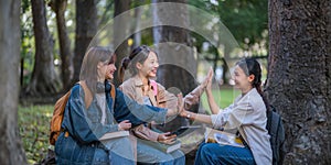 Student university friendship concept with classmate sitting together at campus college park. Youth teenage and