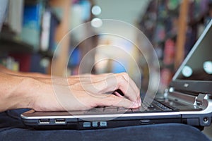 Student use computer laptop for search data. Student sitting in library of university and find information on computer.