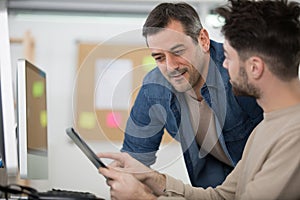 student using computer asking teacher question