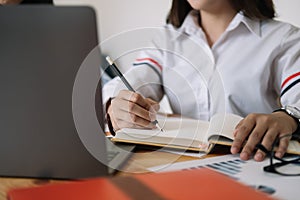 Student using computer laptop for training online and writing lecture note. e-learning education concept