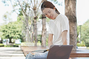 student using internet search data for doing homework from computer in campus