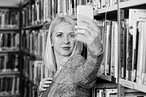 Student Using Mobile Phone for Selfie in Library