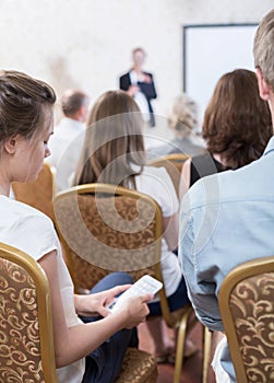 Student using phone during conference