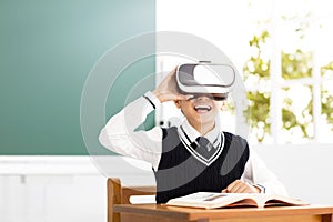 Student with virtual reality headset sitting in classroom