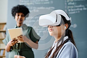 Student in VR glasses sitting at lesson